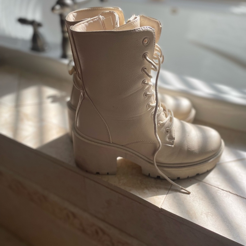 White ankle boots with a heel.